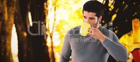 Composite image of thoughtful young man looking away while having coffee