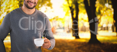 Composite image of portrait of smiling confident man holding tea cup