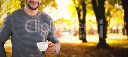 Composite image of portrait of smiling confident man holding tea cup