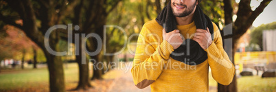 Composite image of smiling man holding scarf