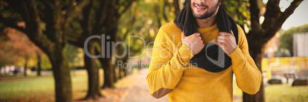 Composite image of smiling man holding scarf