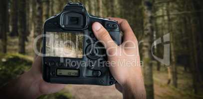 Composite image of cropped image of hands holding camera