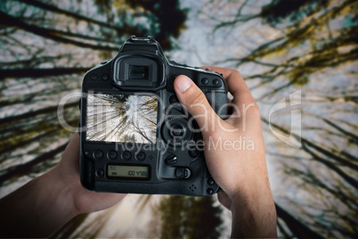 Composite image of cropped image of hands holding camera