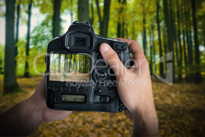 Composite image of cropped image of hands holding camera