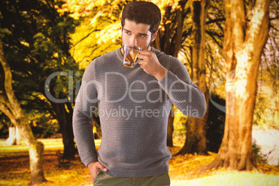 Composite image of confident young man drinking lemon tea