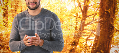 Composite image of portrait of smiling man holing tea cup