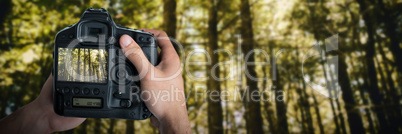 Composite image of cropped image of hands holding camera