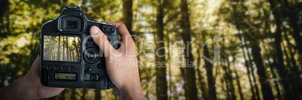 Composite image of cropped image of hands holding camera