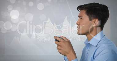 Businessman playing with computer game controller with bright charts background