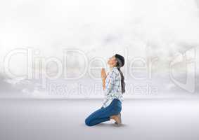 Woman praying under clouds