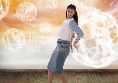 Businesswoman holding back glowing orb spheres