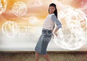 Businesswoman holding back glowing orb spheres