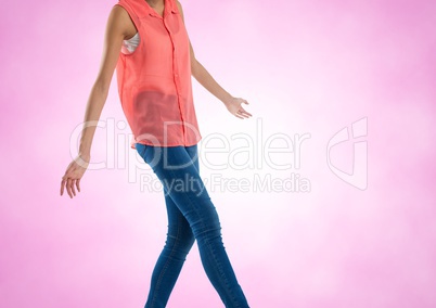 Slim woman mid section of body walking with pink background