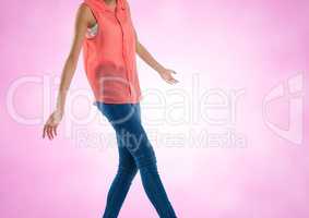 Slim woman mid section of body walking with pink background