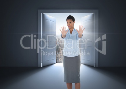 Businesswoman  with hands out stopping in front of open door