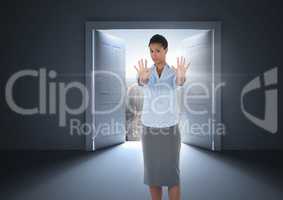 Businesswoman  with hands out stopping in front of open door