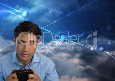 Businessman playing with computer game controller with sky connections background