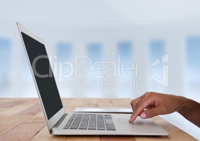 Business hand at desk with laptop with bright background