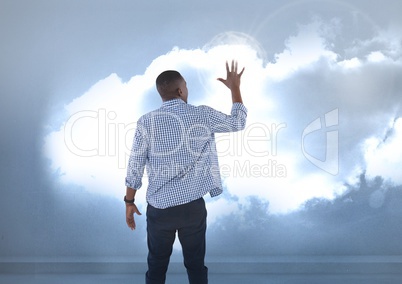 Businessman touching illuminated clouds