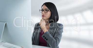Businesswoman at desk with copmuter with bright background