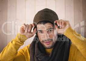 Man against wood with warm scarf and hat