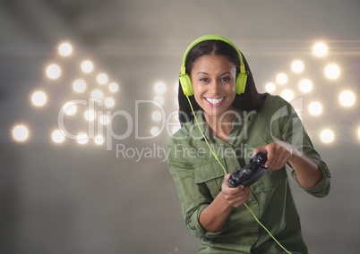 Businesswoman playing with computer game controller with stadium lights background