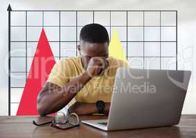 Businessman at desk with laptop and grid chart