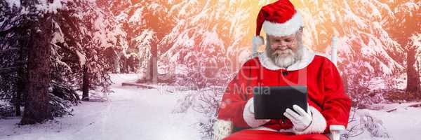 Santa with Winter landscape using tablet