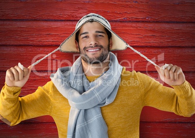 Man against wood with warm hat and scarf