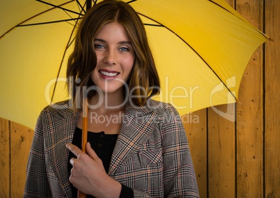Woman against wood with umbrella