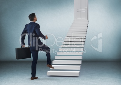 Businessman with briefcase walking up stairs to door