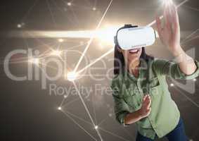 woman playing with virtual reality headset with light connections background