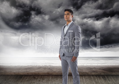 Businessman standing by dark sea