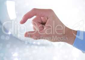 Hand interacting and pinching the air with bright sparkling light background