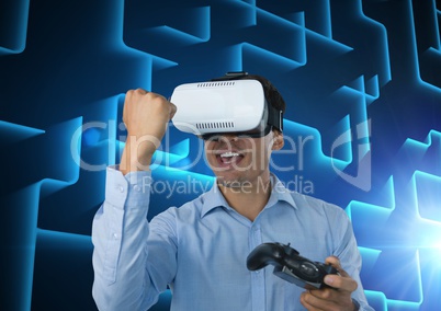 Businessman playing with computer game controller with blue maze background