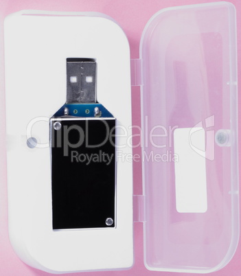 electronic device in plastic case on pink background at day