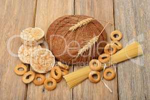 bread, pasta and pastries on wooden background