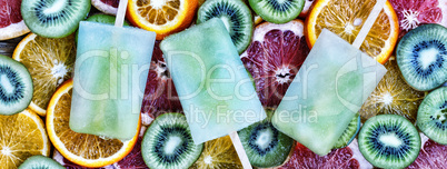 Concept: summer, heat, quenching thirst. Fruit ice, sliced fruit, kiwi, orange, grapefruit.
