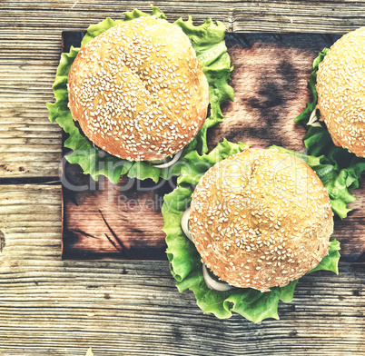 Rustic style, top view. Hamburger on a wooden table. Rustic