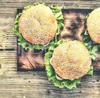 Rustic style, top view. Hamburger on a wooden table. Rustic