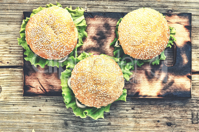 Rustic style, top view. Hamburger on a wooden table. Rustic