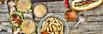 hot dogs and beer on a wooden table. Rustic style, top view homemade burgers with beef