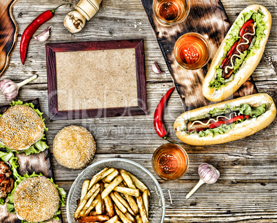 hot dogs and beer on a wooden table. Rustic style, top view homemade burgers with beef