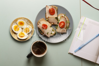Healthy breakfast..Sandwiches,  hard-boiled eggs, black organic coffee