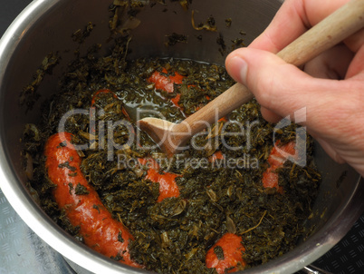 Cooked kale with smoked sausages
