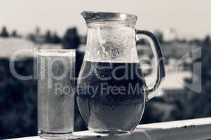 Summer time. Crafting a beer in a jug and a glass.