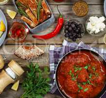 Dining table. Meatballs With parsley and cherry tomatoes and various snacks.