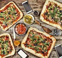 Friendly feast at home. Appetizing homemade pizza on a wooden table.