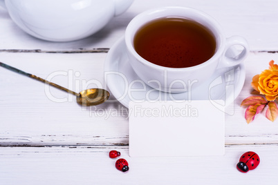 black tea in a round white cup with a saucer