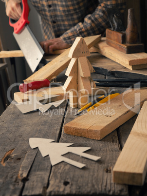 Joiner making a wooden Christmas decoration
